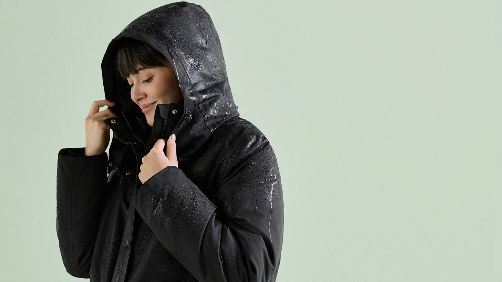 Zimní outfit: černá parka, hnědý rolák, černé džíny a robustní béžové kozačky.
